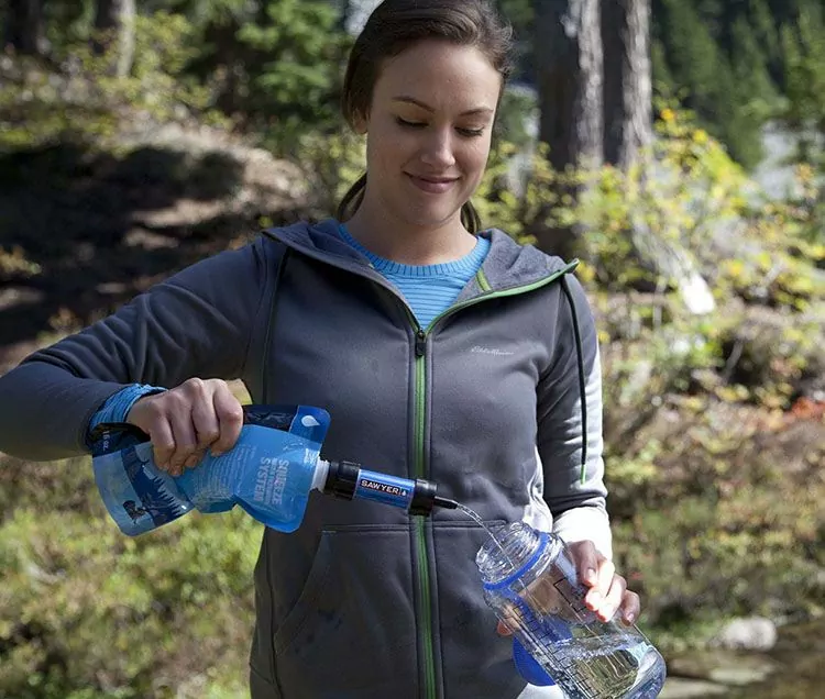 filling a bottle with the sawyer mini water filter